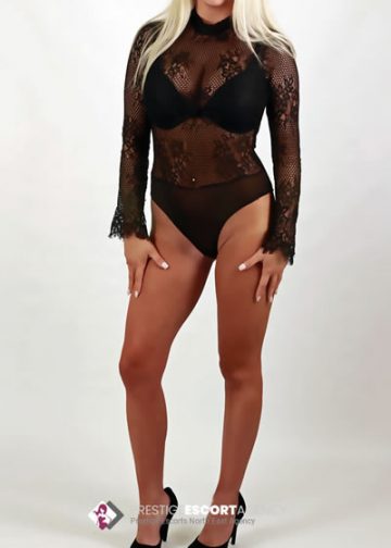 Woman in black lace lingerie and heels.