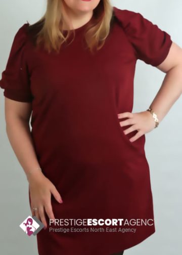 Woman in red dress from Prestige Escorts Agency.